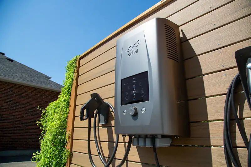 Wall-mounted EV charger on a wood wall